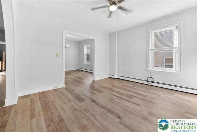 wooden floor in an empty room with a window