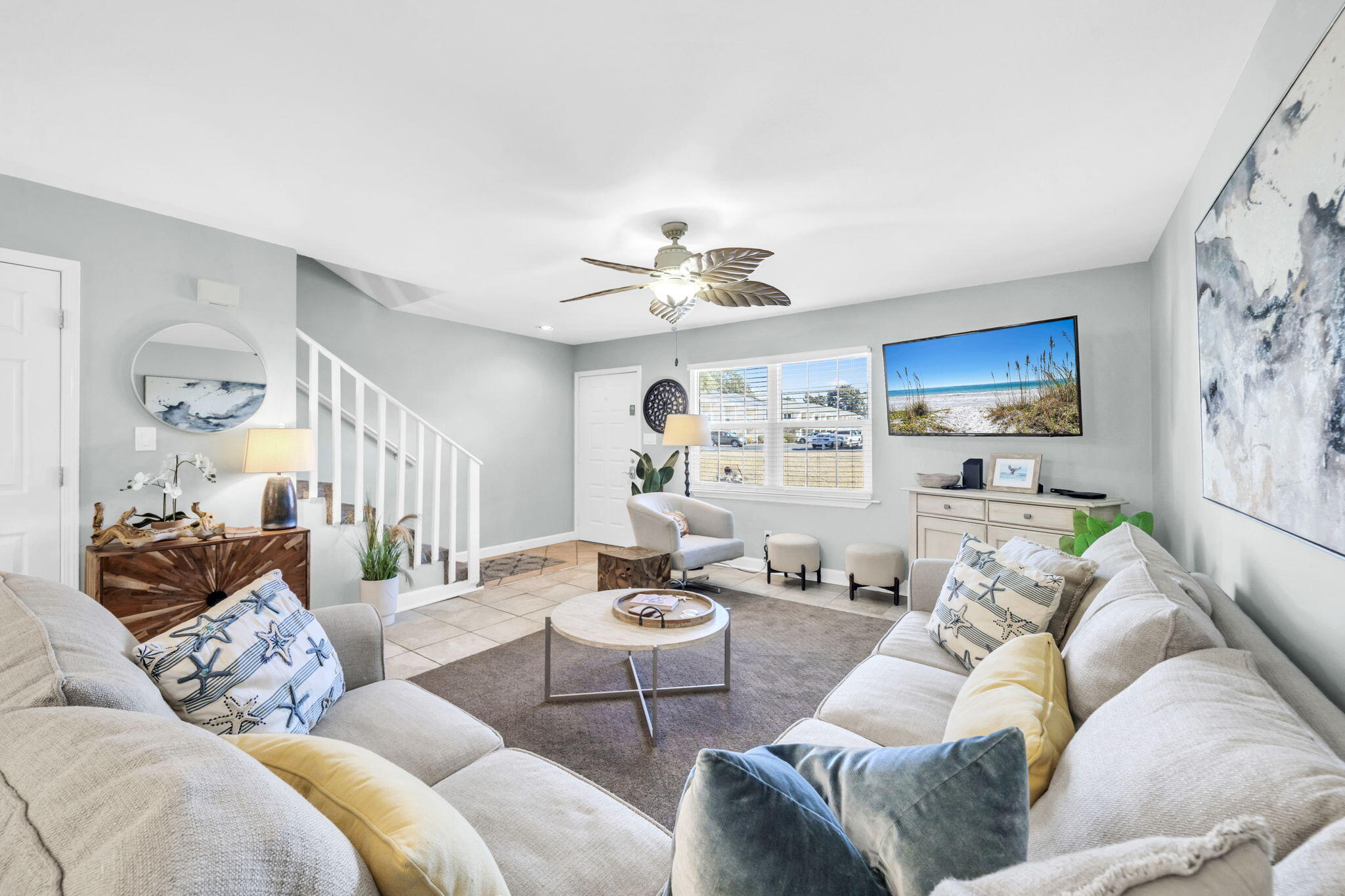 a living room with furniture and a chandelier