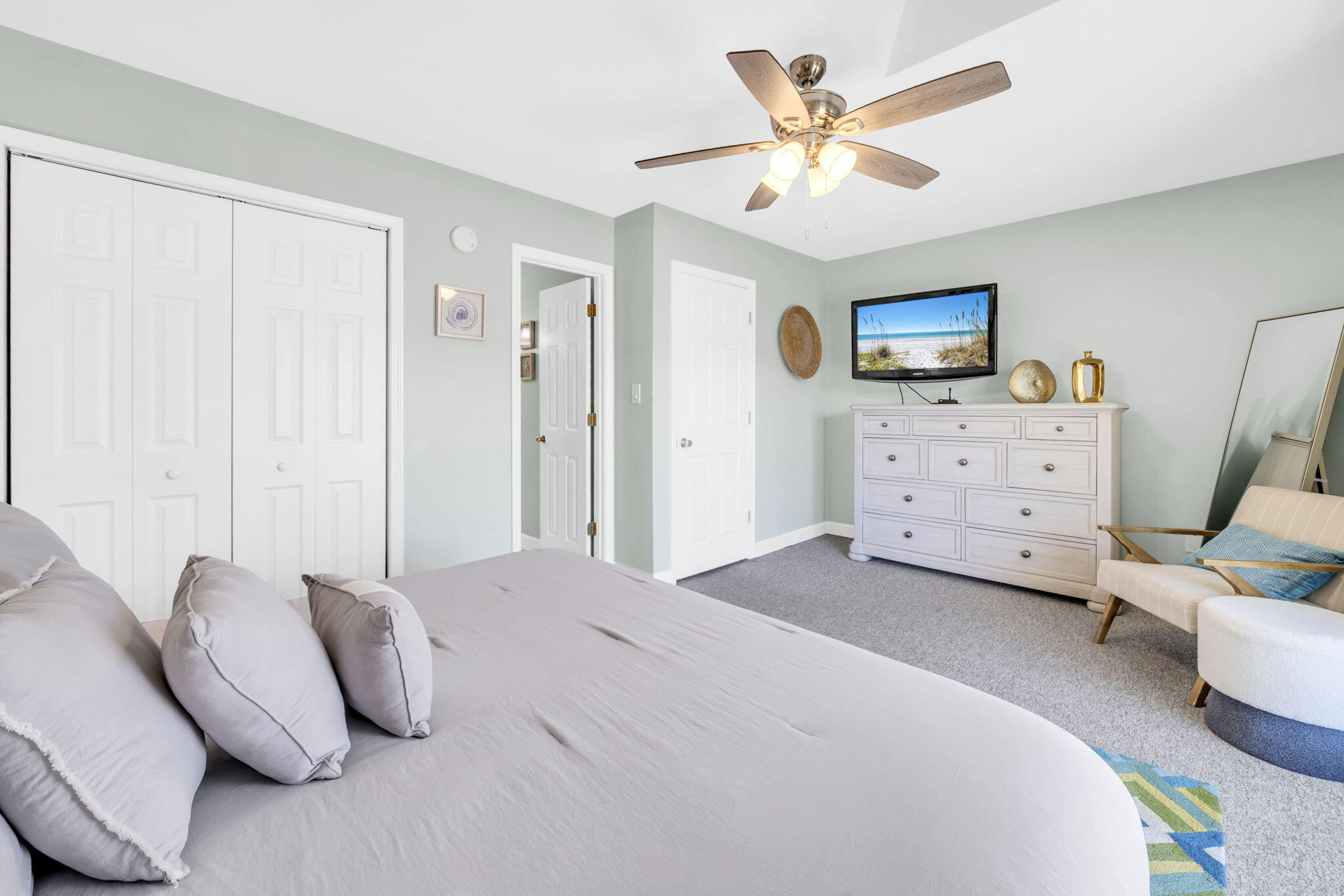 241 Ellis Road, Unit 43 Miramar Beach, FL 32550 - Photo 21 of 49 a spacious bedroom with a bed a couch and a ceiling fan