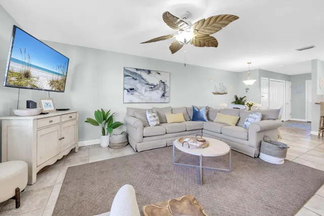 a spacious bedroom with a bed a couch and a ceiling fan