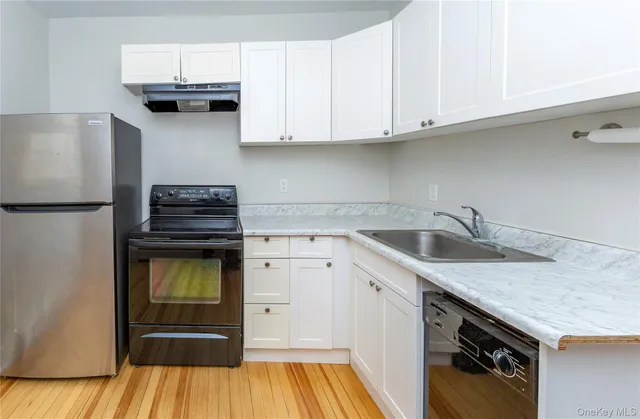 a kitchen with a sink and a refrigerator