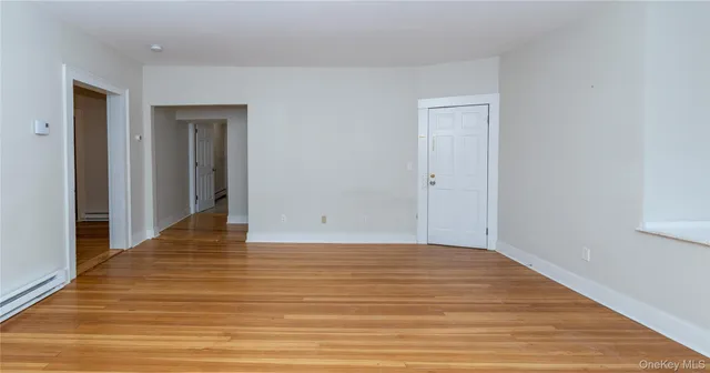 a view of a room with wooden floor