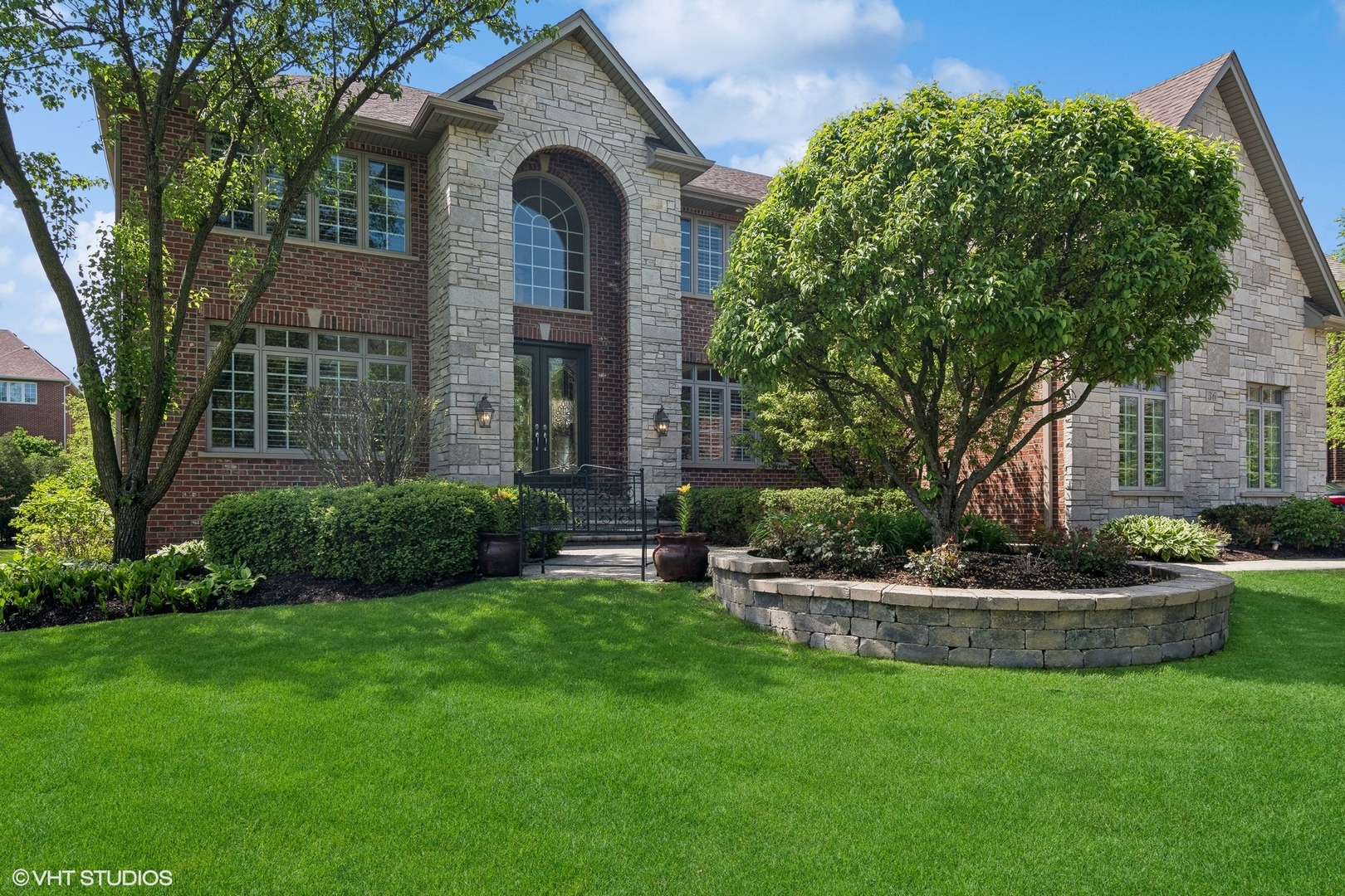 a front view of a house with a garden