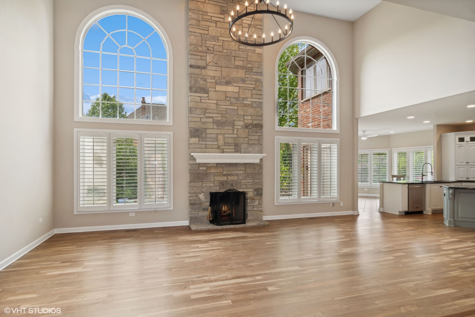 36 Ford Lane Naperville, IL 60565 - Photo 11 of 42 a view of an empty room with a fireplace and wooden floor