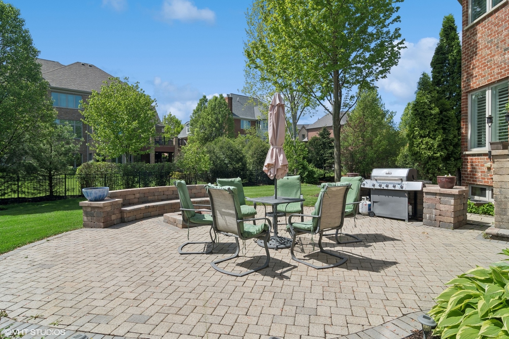 36 Ford Lane Naperville, IL 60565 - Photo 35 of 42 a view of a patio with table and chairs potted plants and a large tree
