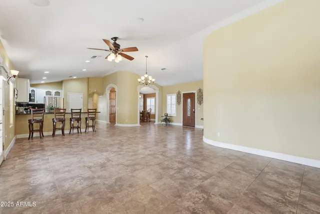 a kitchen with stainless steel appliances granite countertop a refrigerator stove and sink