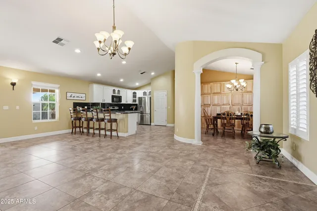a spacious bathroom with a tub and a large window