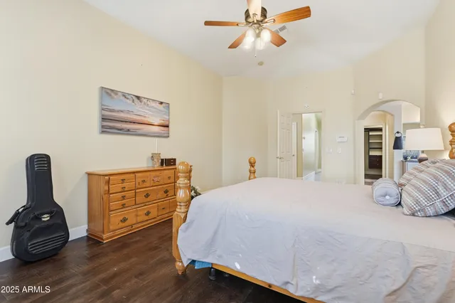a bedroom with a bed and a chandelier