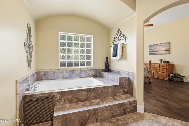 a bedroom with furniture and wooden floor