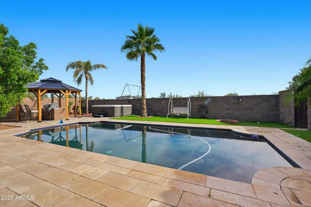 a view of a house with a yard and palm trees