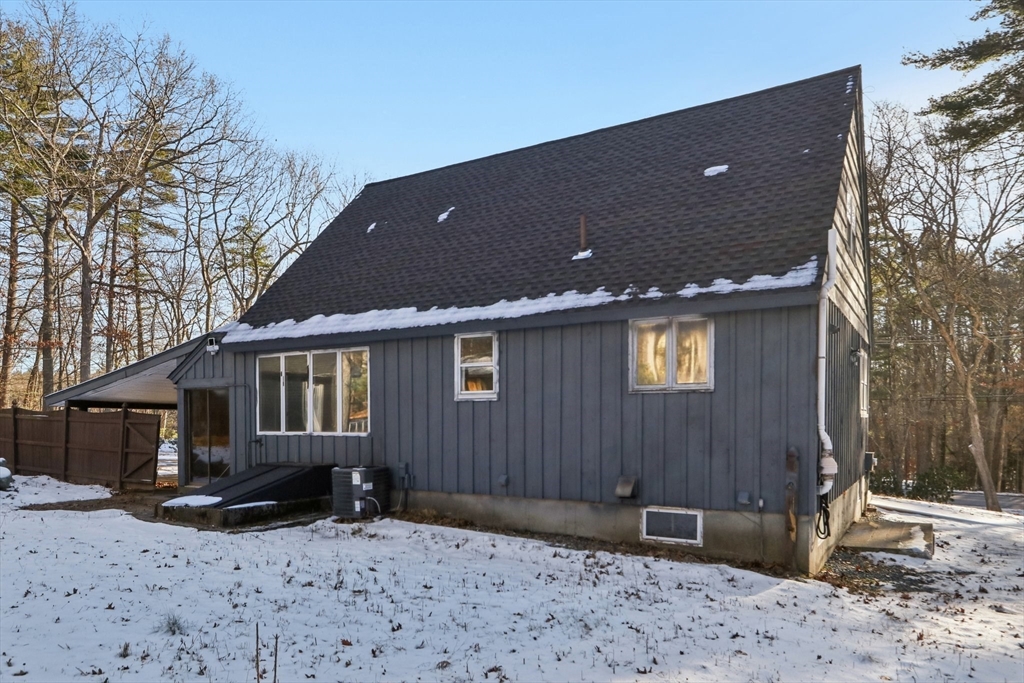 143 Hudson Road Stow, MA 01775 - Photo 11 of 42 a backyard of a house with wooden fence and a tree