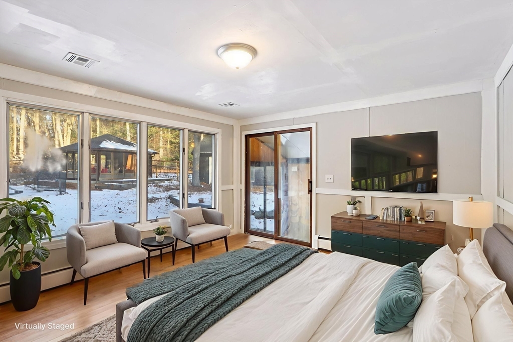 143 Hudson Road Stow, MA 01775 - Photo 18 of 42 a bedroom with furniture and a flat screen tv