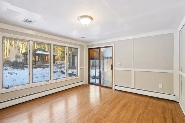 a kitchen with kitchen island a sink and a stove with wooden floor