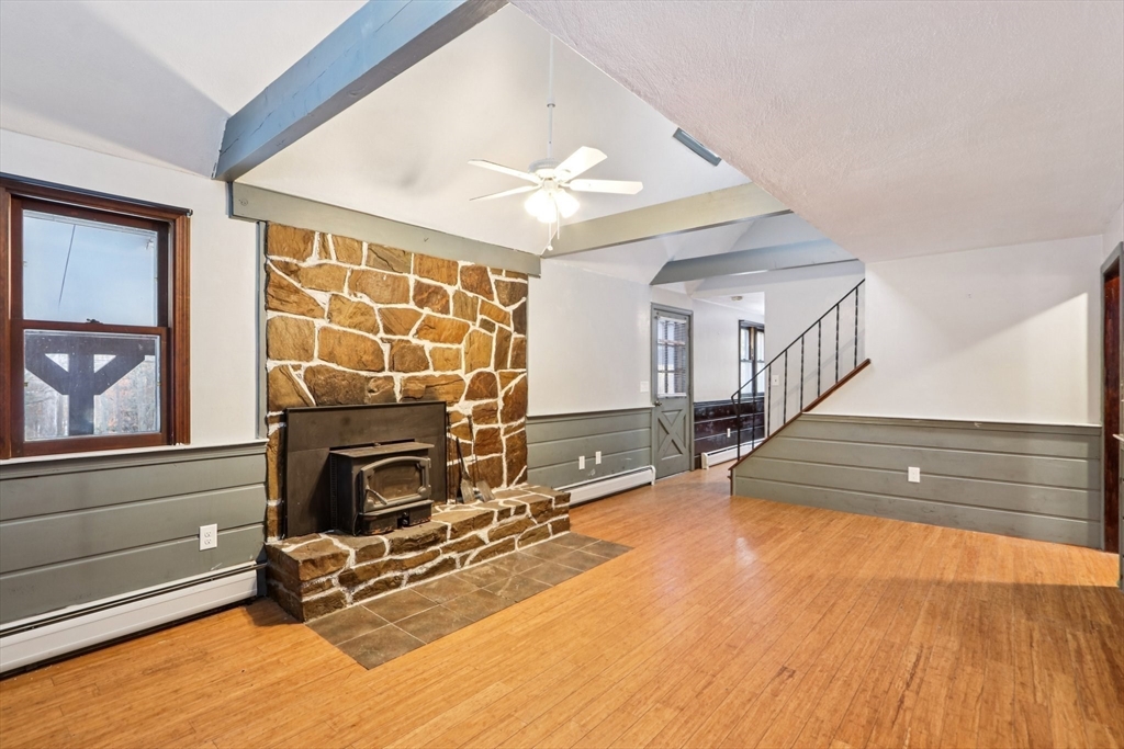 143 Hudson Road Stow, MA 01775 - Photo 21 of 42 a view of a livingroom with wooden floor and a fireplace