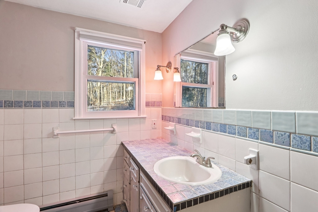 143 Hudson Road Stow, MA 01775 - Photo 25 of 42 a bathroom with a granite countertop sink and a mirror
