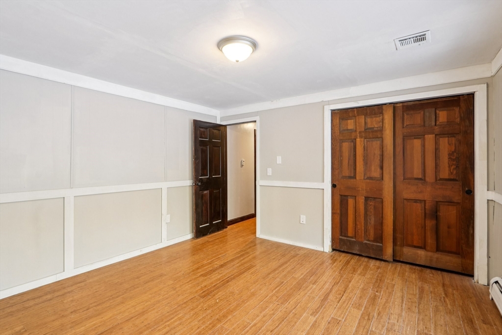 143 Hudson Road Stow, MA 01775 - Photo 27 of 42 a view of an empty room with wooden floor