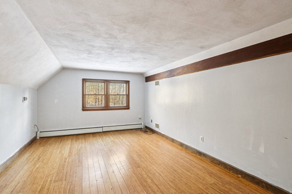 143 Hudson Road Stow, MA 01775 - Photo 30 of 42 an empty room with wooden floor and windows