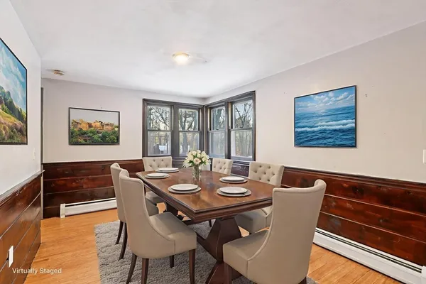 a view of a dining room with furniture window and wooden floor