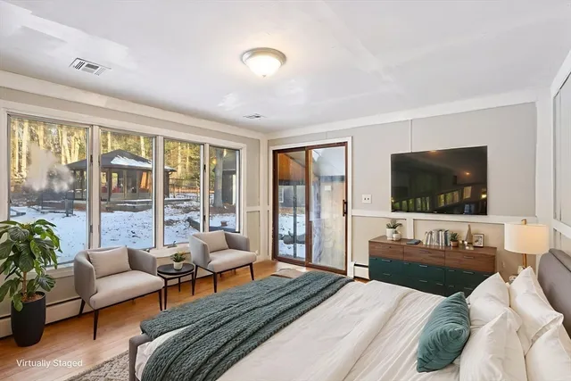 a bedroom with furniture and a flat screen tv