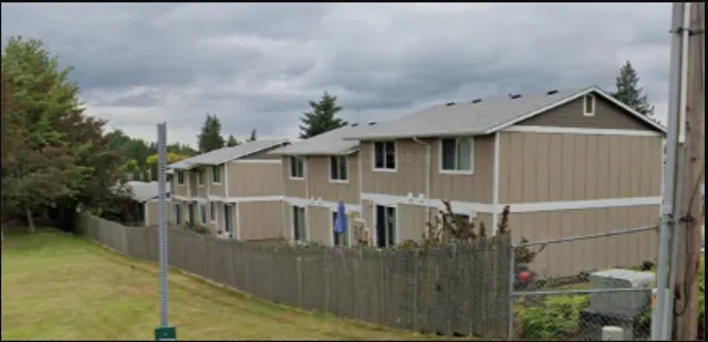 a view of a house with wooden fence