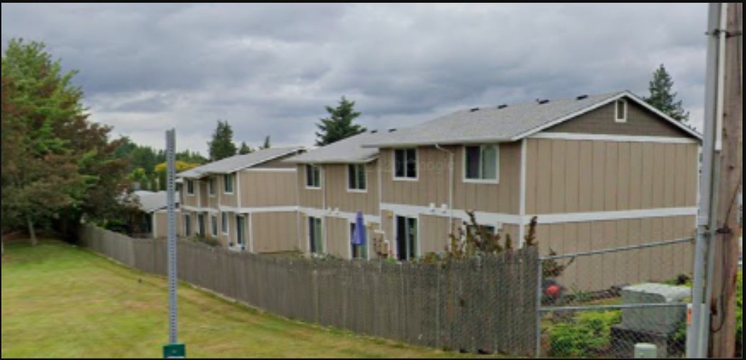 a view of a house with wooden fence
