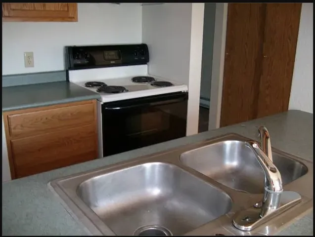 a kitchen with a stove and cabinets