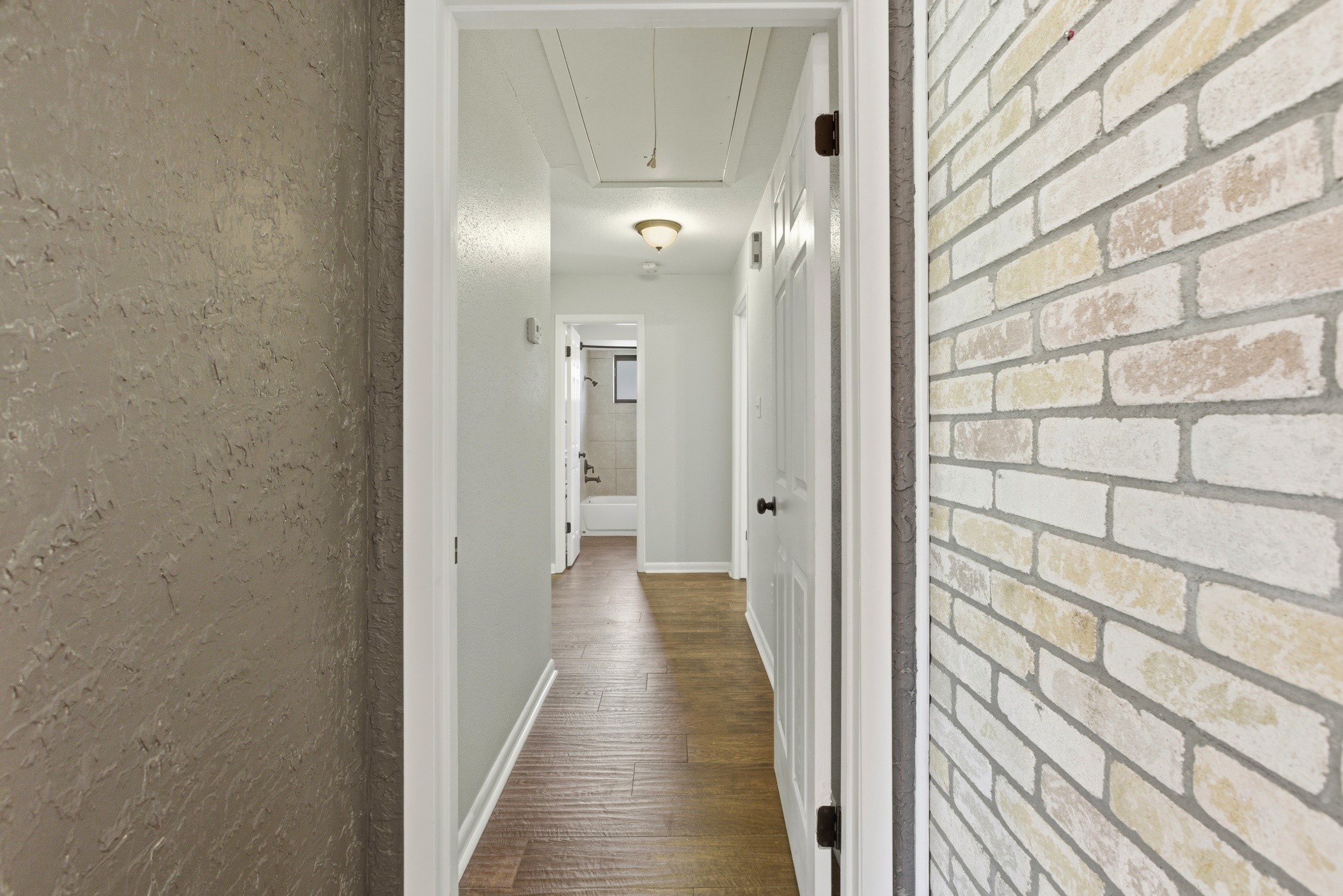 3721 Avenue R Rosenberg, TX 77471 - Photo 24 of 43 Hallway off the living room leading to all bedrooms and baths, with wood-look tile flooring throughout.