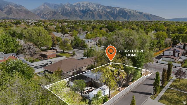 901 East 7800 South Midvale, UT 84047 - Photo 1 of 1 Aerial view of residential area with property parcel outlined and a mountainous background