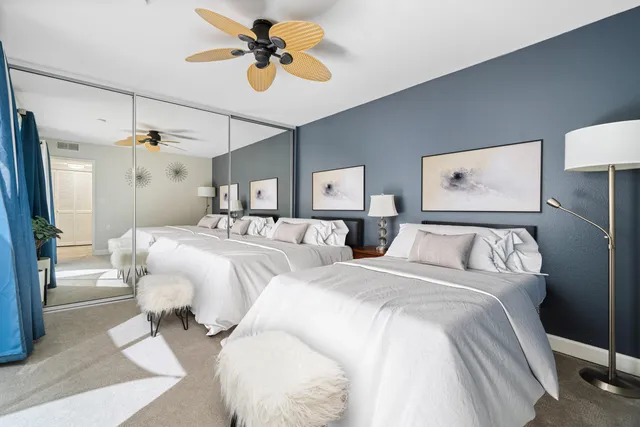 a bedroom with three beds and a chandelier