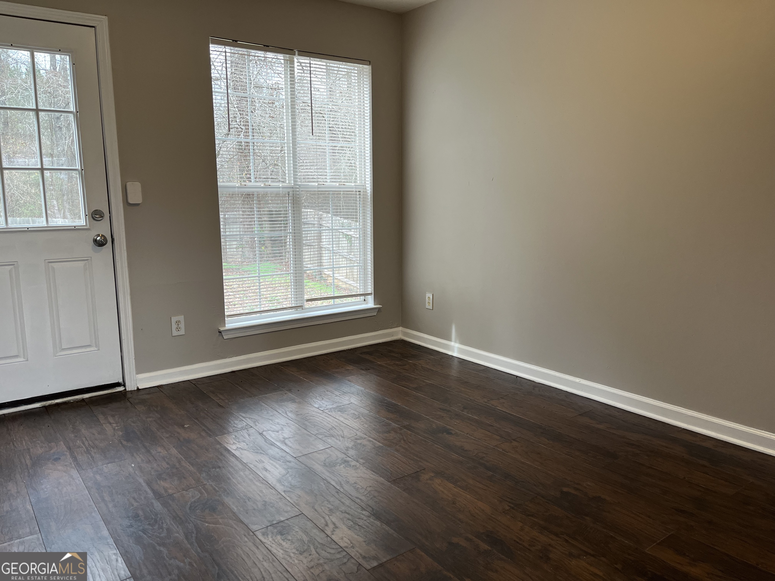 156 Galway Lane Hampton, GA 30228 - Photo 11 of 44 an empty room with wooden floor and windows
