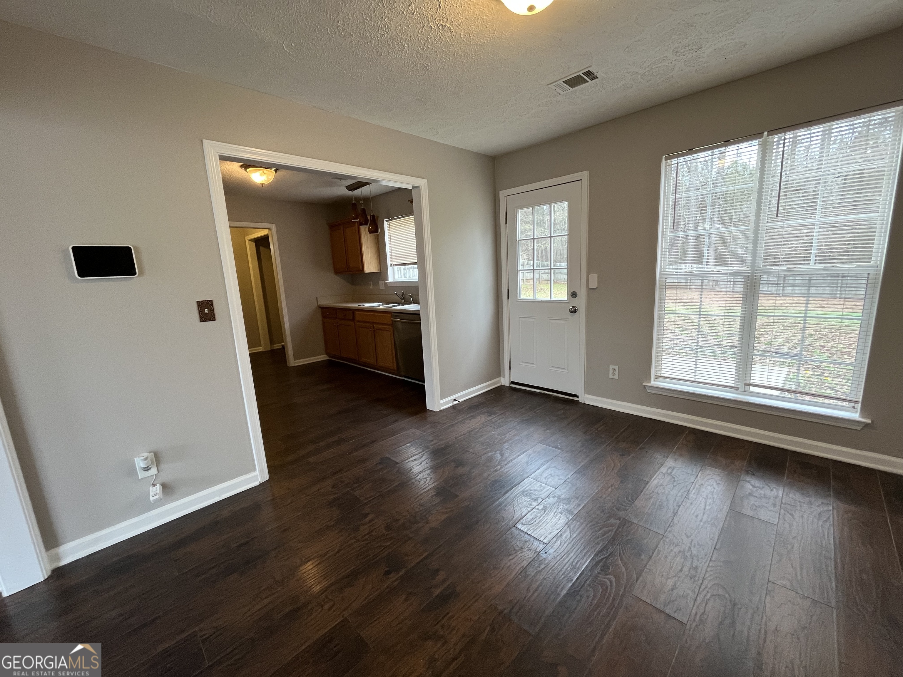 156 Galway Lane Hampton, GA 30228 - Photo 12 of 44 wooden floor in an empty room with a window