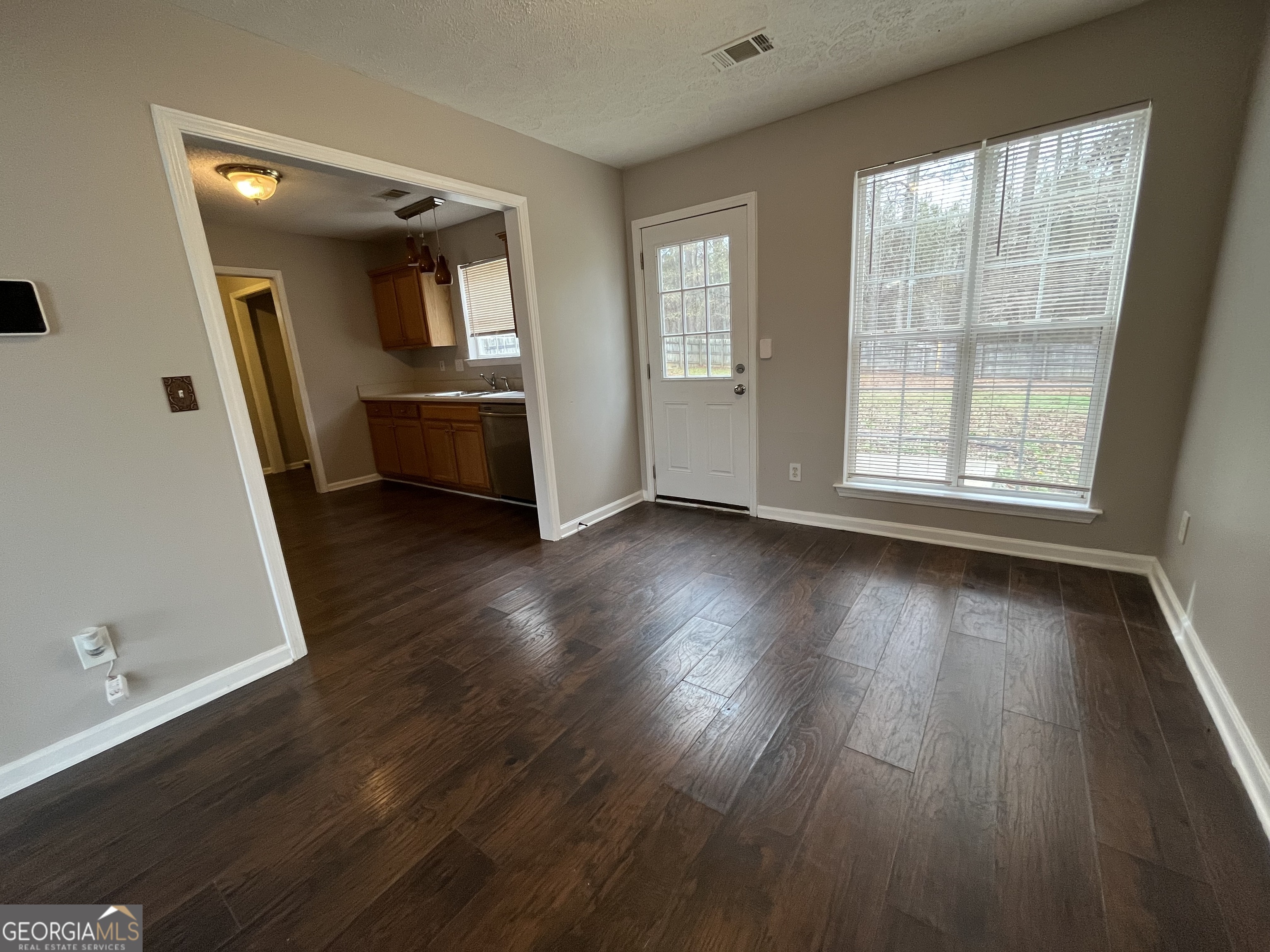156 Galway Lane Hampton, GA 30228 - Photo 13 of 44 an empty room with wooden floor and windows