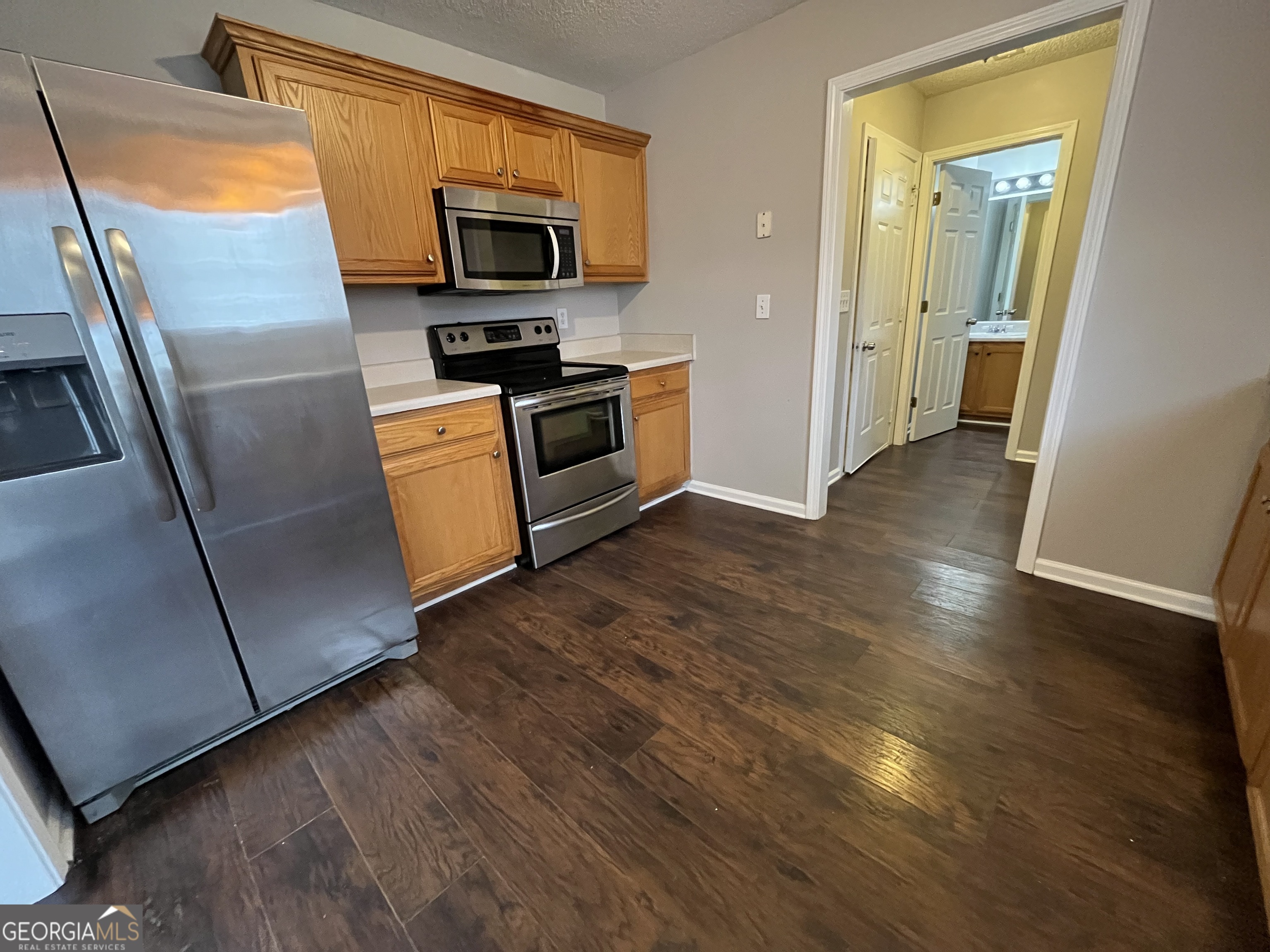 156 Galway Lane Hampton, GA 30228 - Photo 14 of 44 a kitchen with stainless steel appliances granite countertop a refrigerator microwave and sink