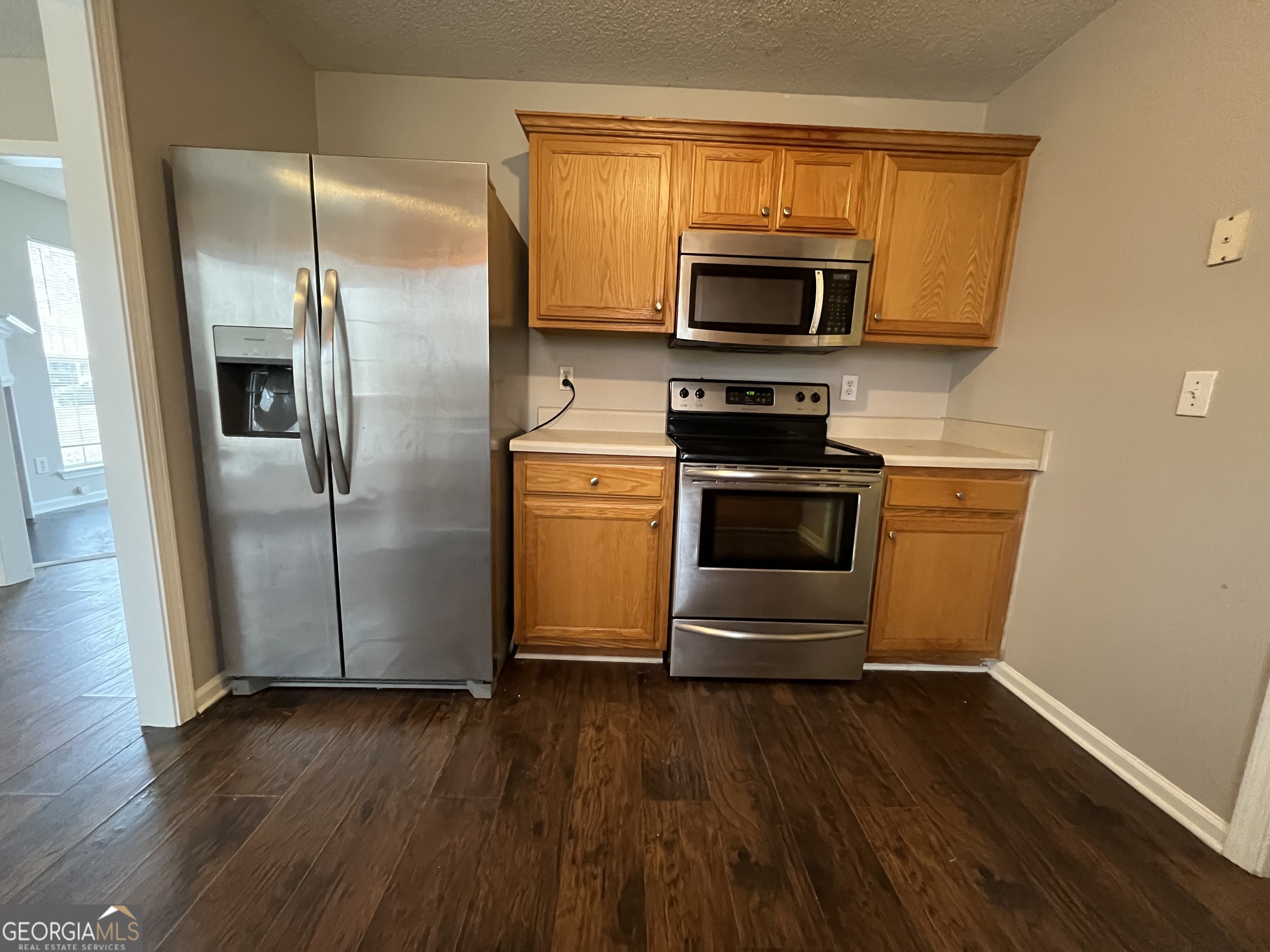 156 Galway Lane Hampton, GA 30228 - Photo 15 of 44 a kitchen with wooden floors and stainless steel appliances