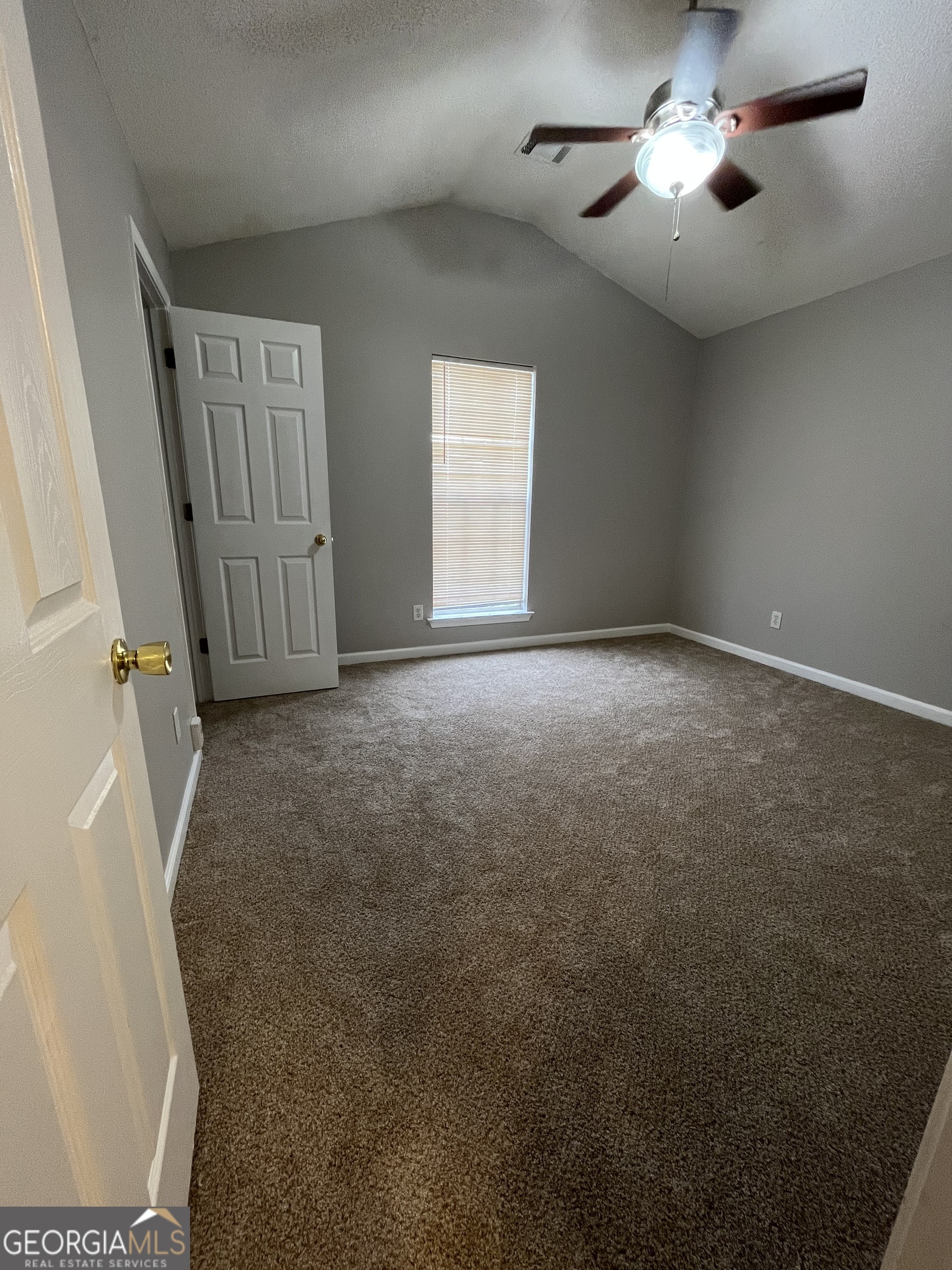 156 Galway Lane Hampton, GA 30228 - Photo 25 of 44 an empty room with windows and fan