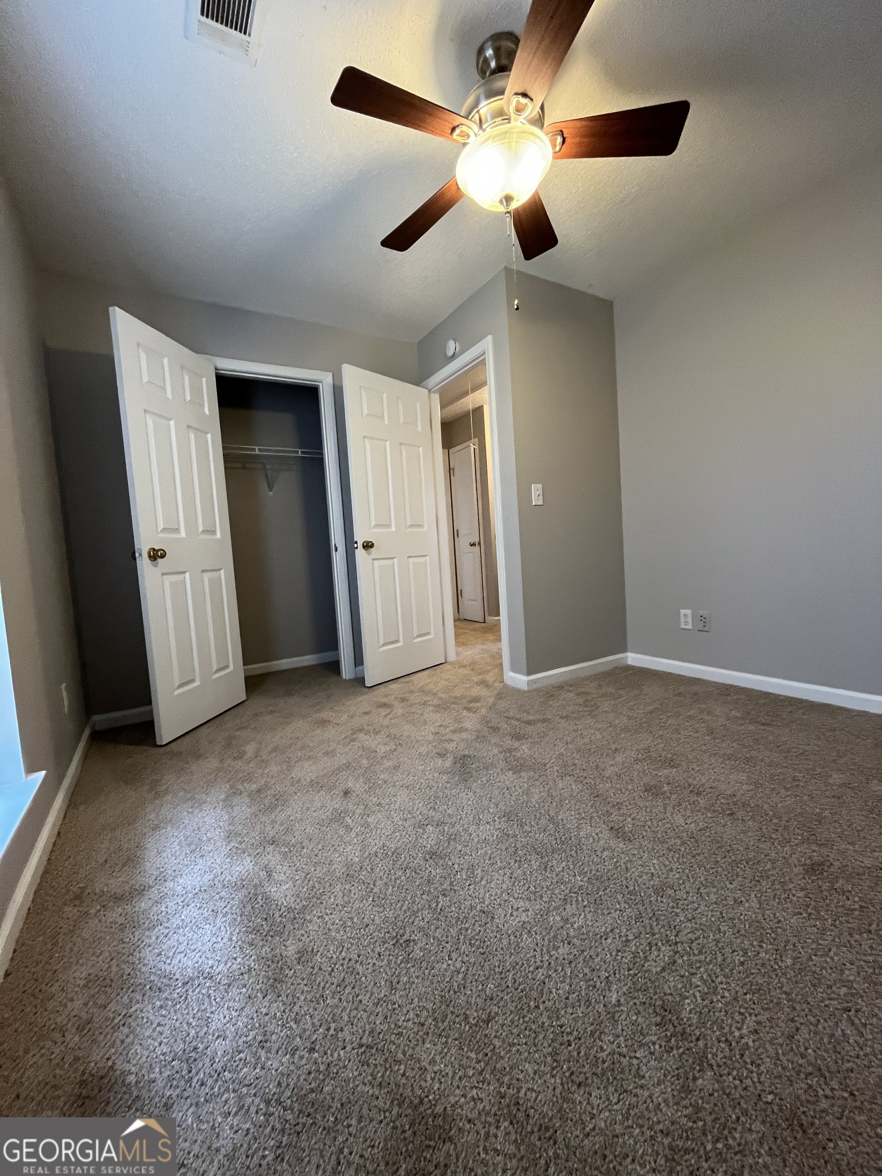 156 Galway Lane Hampton, GA 30228 - Photo 30 of 44 an empty room with closet and windows