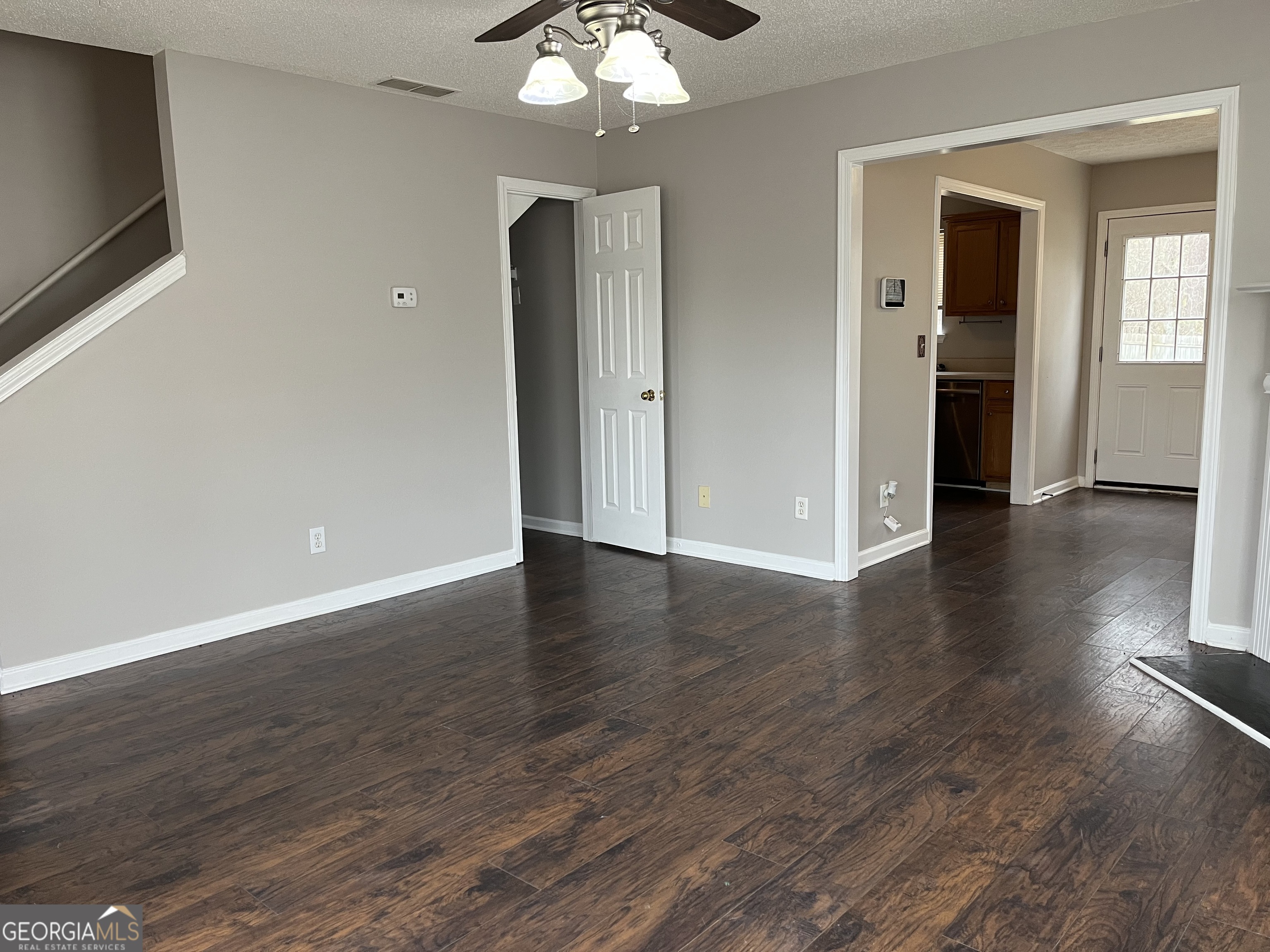 156 Galway Lane Hampton, GA 30228 - Photo 9 of 44 an empty room with wooden floor and windows