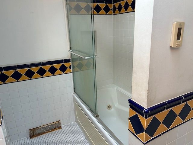 a bathroom with a shower and a sink