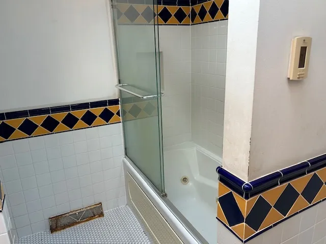a bathroom with a shower and a sink