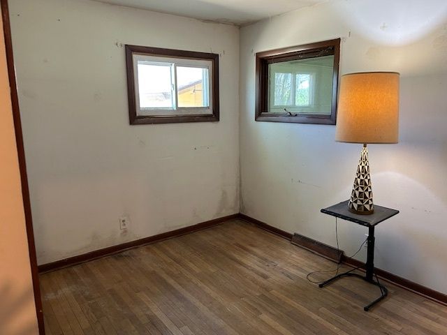 a view of a livingroom with a window and wooden floor