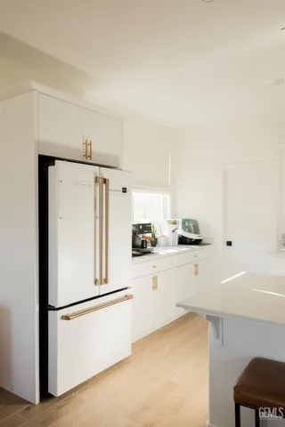 a white refrigerator freezer sitting inside of a kitchen