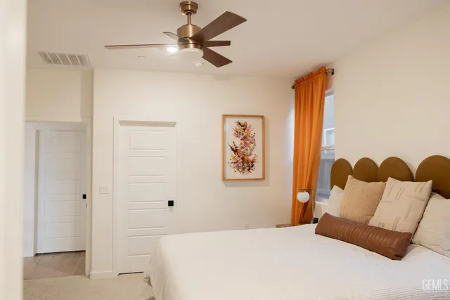 a bedroom with a bed and a painting on the wall