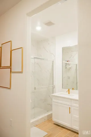 a bathroom with a bathtub shower sink and mirror