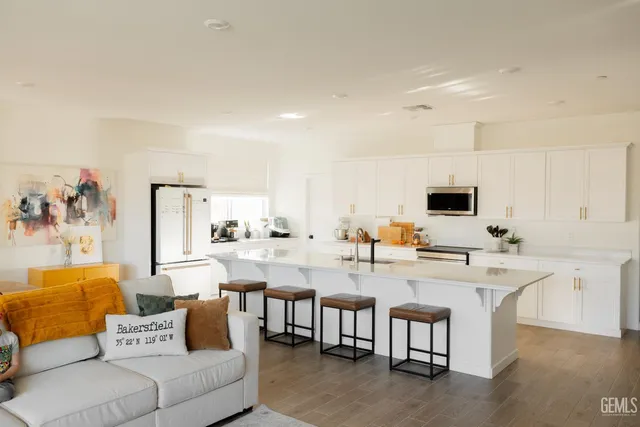 a view of a dining room with furniture and a kitchen