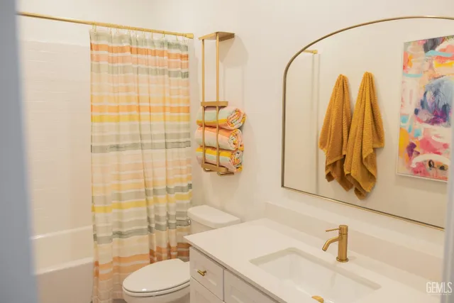 a bedroom with a bed and a mirror on the dresser