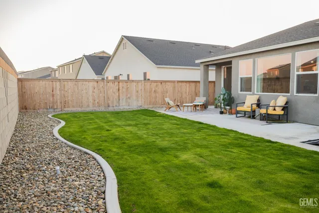 a view of a chair and table on the wooden deck