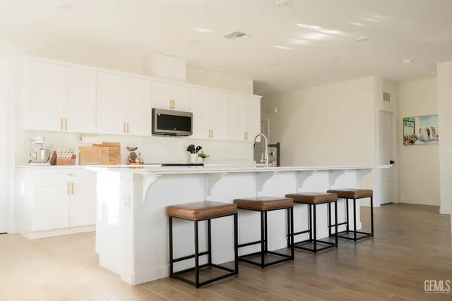 a kitchen with a sink cabinets and wooden floor