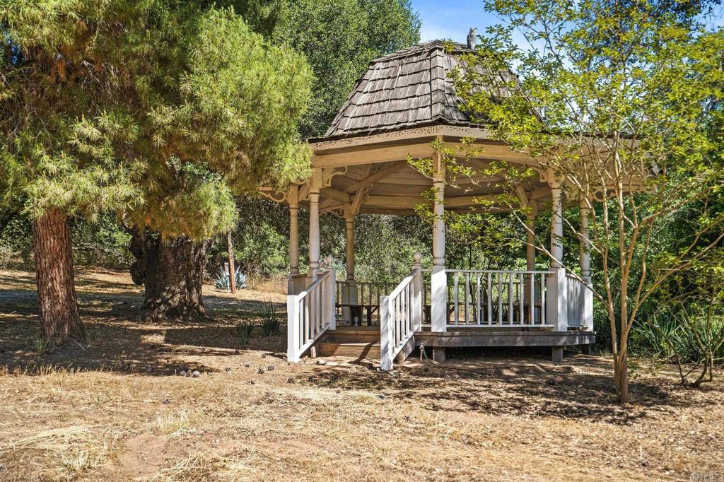13511 Hilldale Road Valley Center, CA 92082 - Photo 24 of 46 a view of wooden house with a small yard and large trees