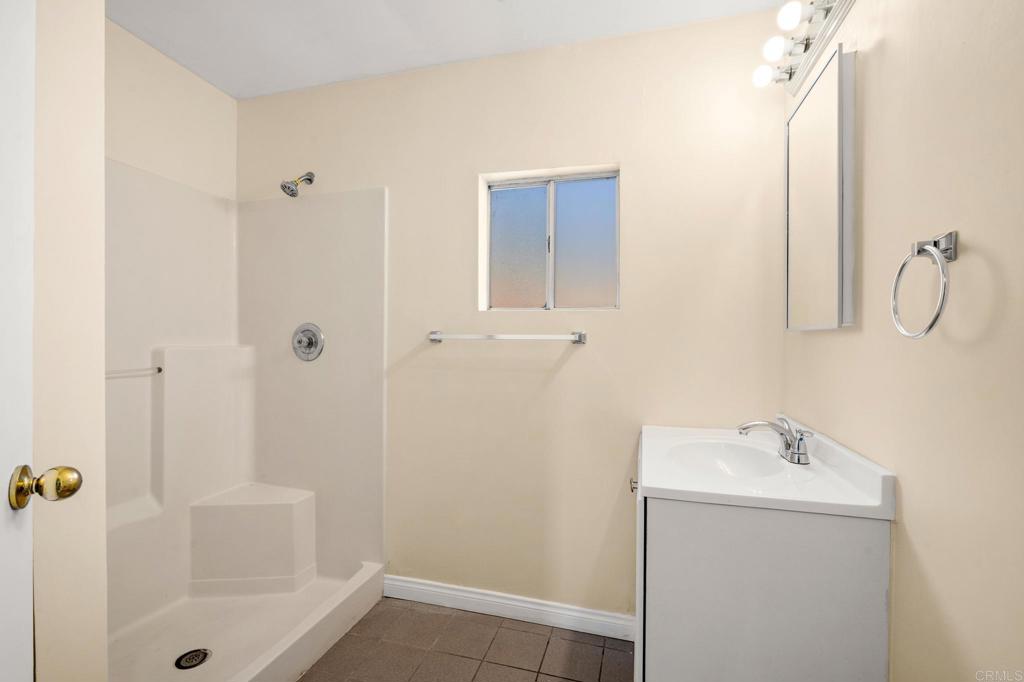 13511 Hilldale Road Valley Center, CA 92082 - Photo 28 of 46 a bathroom with a shower sink and mirror