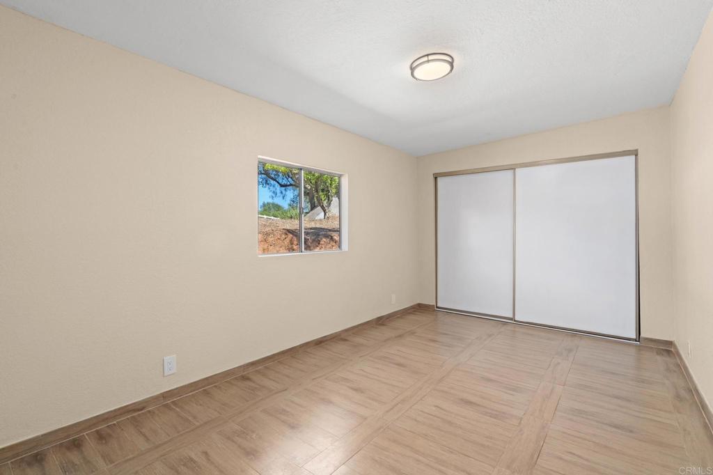 13511 Hilldale Road Valley Center, CA 92082 - Photo 29 of 46 an empty room with a painting and a lamp